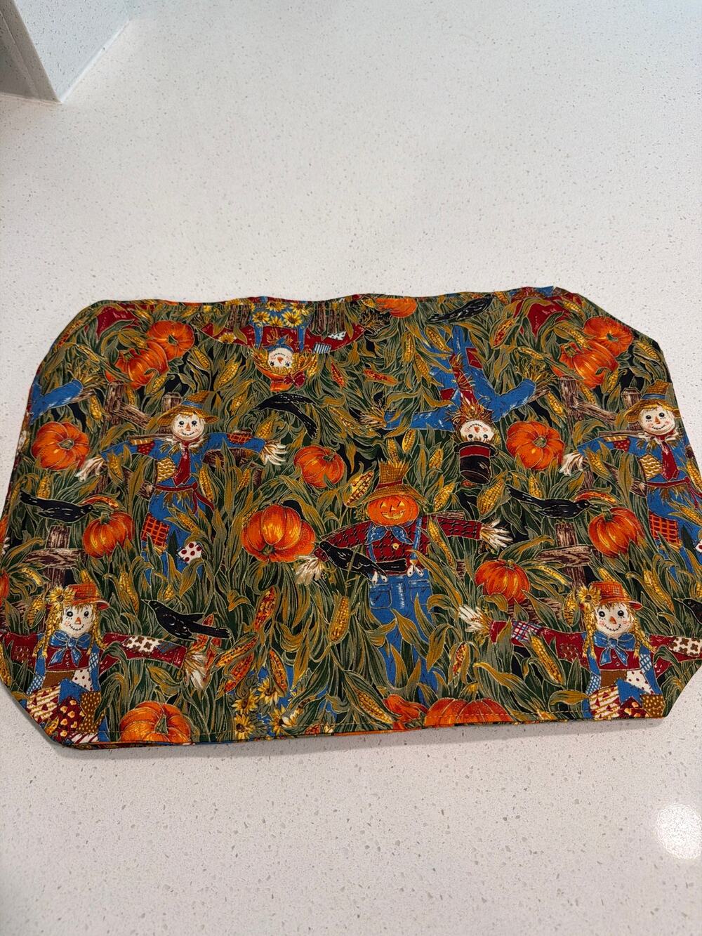 4 fall placemats with scarecrows, pumpkins, crows and cornstalks